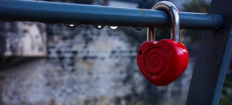 A heart-shaped lock on a railing