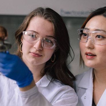 Two researchers holding new copper coating