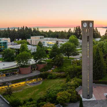 Aerial shot of UBC Vancouver campus and clock tower at sunset