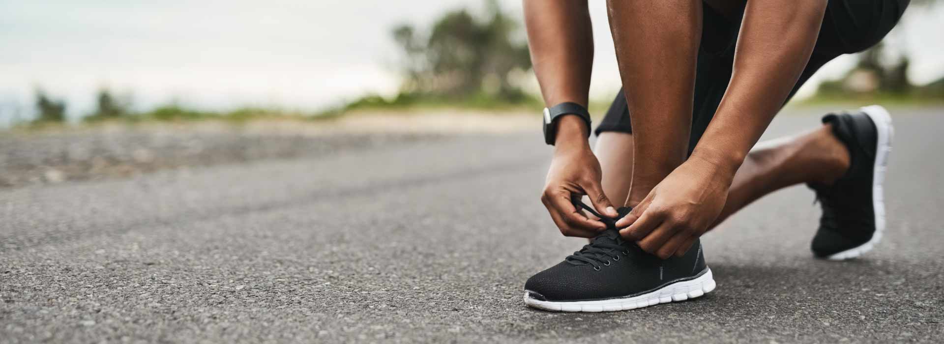 Person tying up shoelace