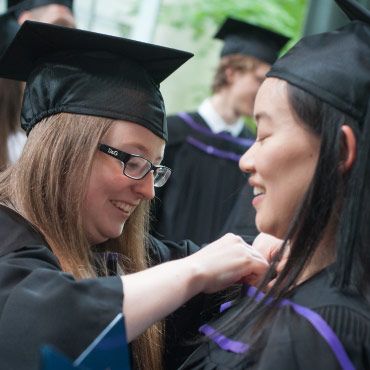 Students getting ready in their graduation gowns and cap