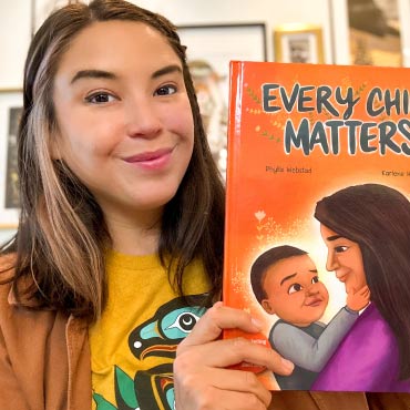 Karlene Harvey holding her book