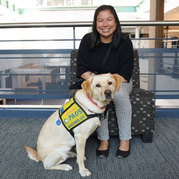 Allison Beardsworth (associate director of strategic Indigenous enrolment initiatives at UBC) and Wilma (assistance dog in training)