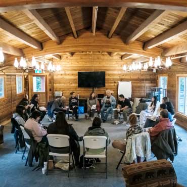 People sitting in a circle in a classroom setting.