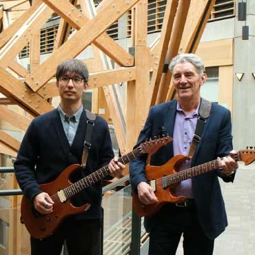 Joseph Doh Wook Kim and Dr. Phil Evans with guitars