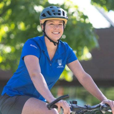 UBC staff member on a bike.