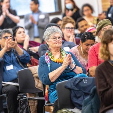 Attendees clapping at the Community Climate Justice Forum