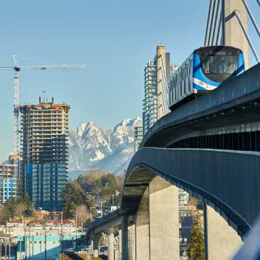 City view of Vancouver with the Canada Line train passing a bridge.