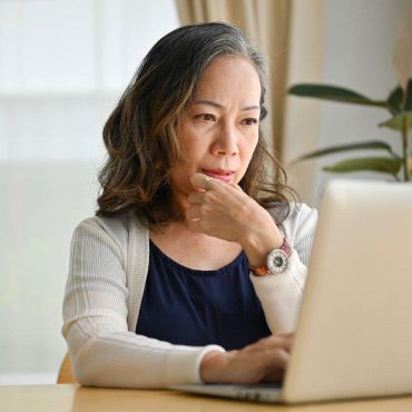 Person on their laptop looking focused.