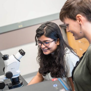 Graduate student Samikshya Sahu with Alannah Hallas examine and discuss experimental materials in Prof. Hallas’ lab at the Stewart Blusson Quantum Matter Institute at UBC.