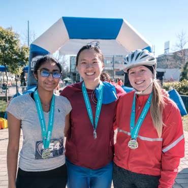 Three UBC triathlon participants with medals